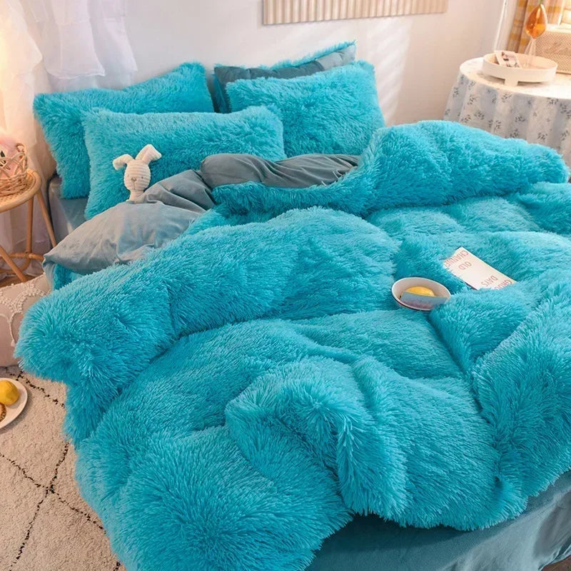 A bright turquoise plush mink velvet duvet set with matching pillows and a gray blanket on a bed.