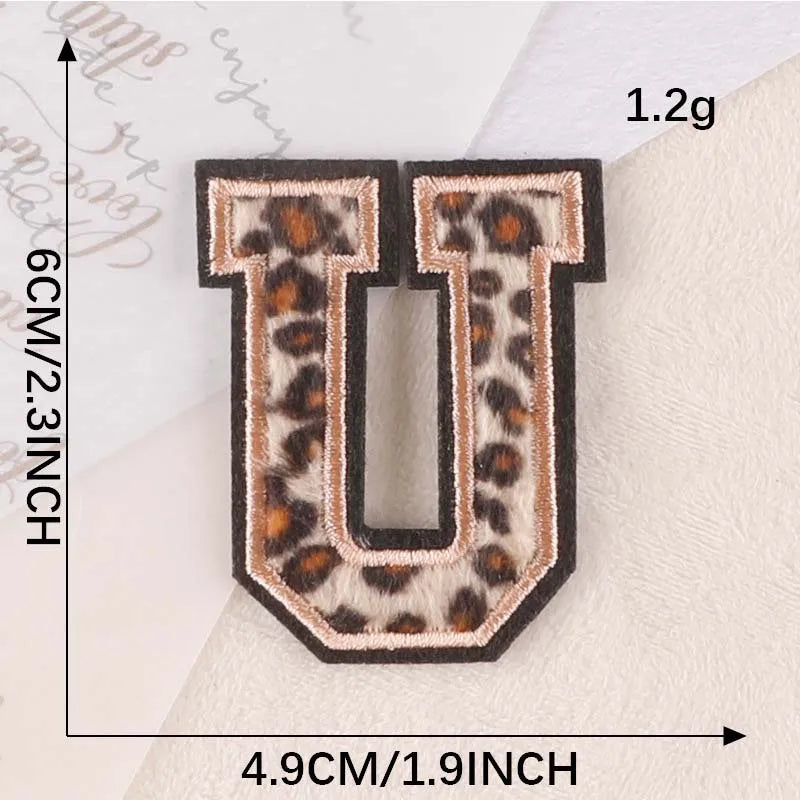 Iron-on patch of the letter U in leopard print fabric on a white background