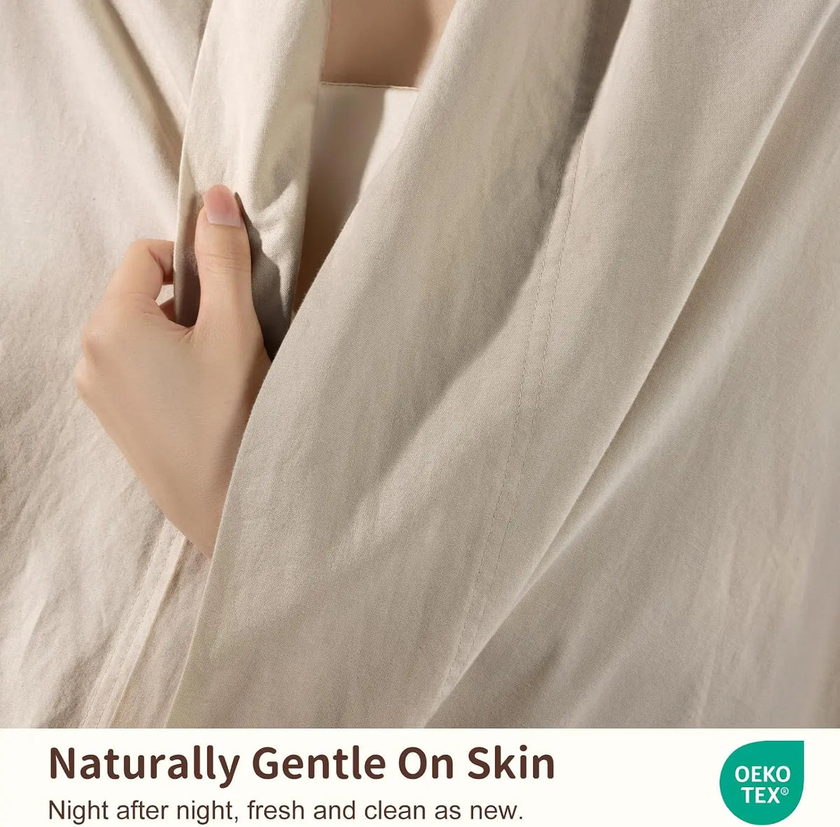 Close-up of a beige pure French linen bed sheet being gently held and draped.