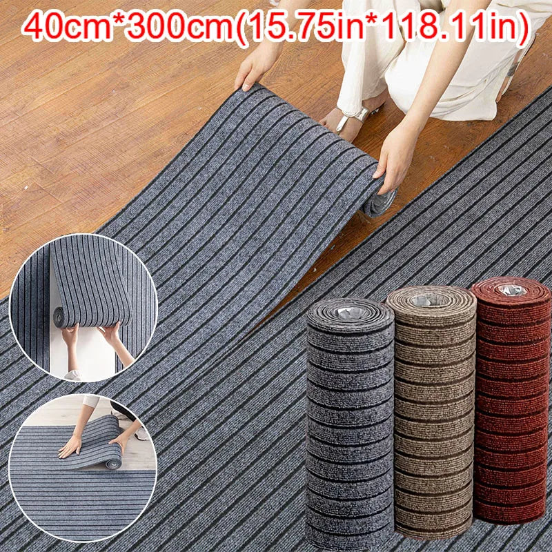 A roll of gray and black striped self-adhesive runner rug being laid out on a wooden floor.