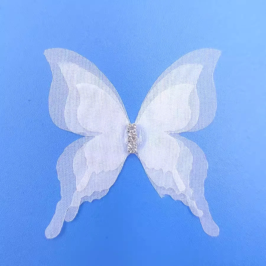 White sheer fabric butterfly tiebacks with silver rhinestone accents