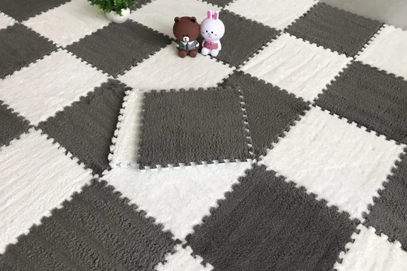 A gray and white checkered rug mat with a square section cut out, featuring two plush animal figures.