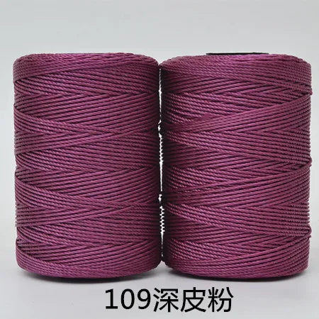 Two spools of magenta hand knitting and crochet cord for crafting