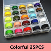 Colorful assortment of 25 sewing thread bobbins in various colors arranged in an open plastic box.