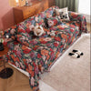 A romantic floral jacquard sofa throw blanket draped over a sofa with decorative pillows.