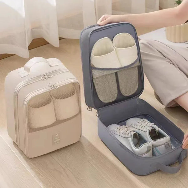 A gray portable travel shoe organizer bag with an open lid showing several pairs of shoes inside.