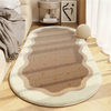 A beige oval rug with striped patterns and a light cream border placed on a wooden floor.