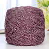 A ball of metallic purple silk yarn used for crocheting and knitting