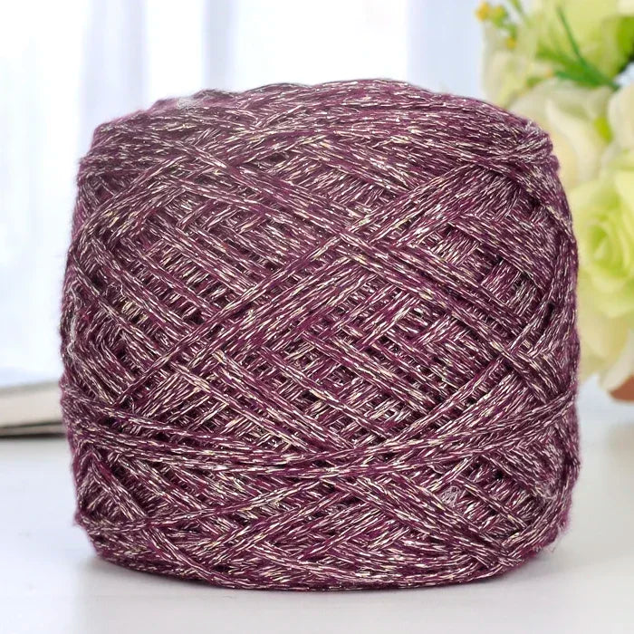 A ball of metallic purple silk yarn used for crocheting and knitting