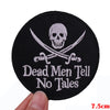 Black embroidered patch featuring a skull and crossed swords with the text Dead Men Tell No Tales