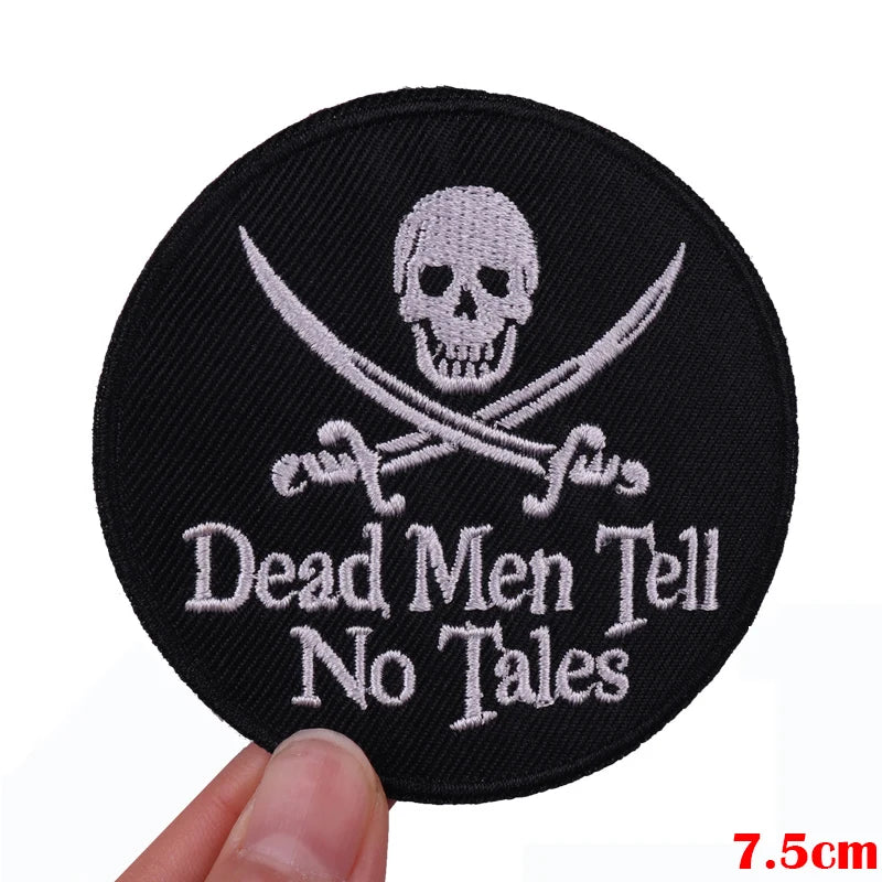 Black embroidered patch featuring a skull and crossed swords with the text Dead Men Tell No Tales