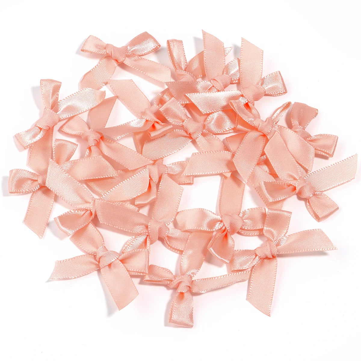 A collection of light pink satin ribbon bows for craft and decoration.