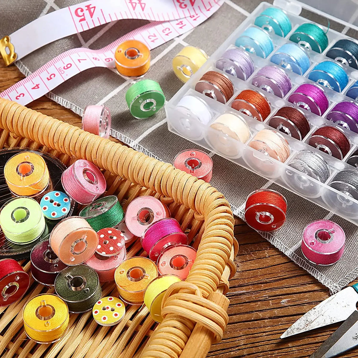 A collection of clear sewing machine bobbins in various colors and sizes arranged in a plastic storage case.