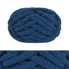 A dark blue hand-knitted wool finger line scarf in a tightly coiled skein.