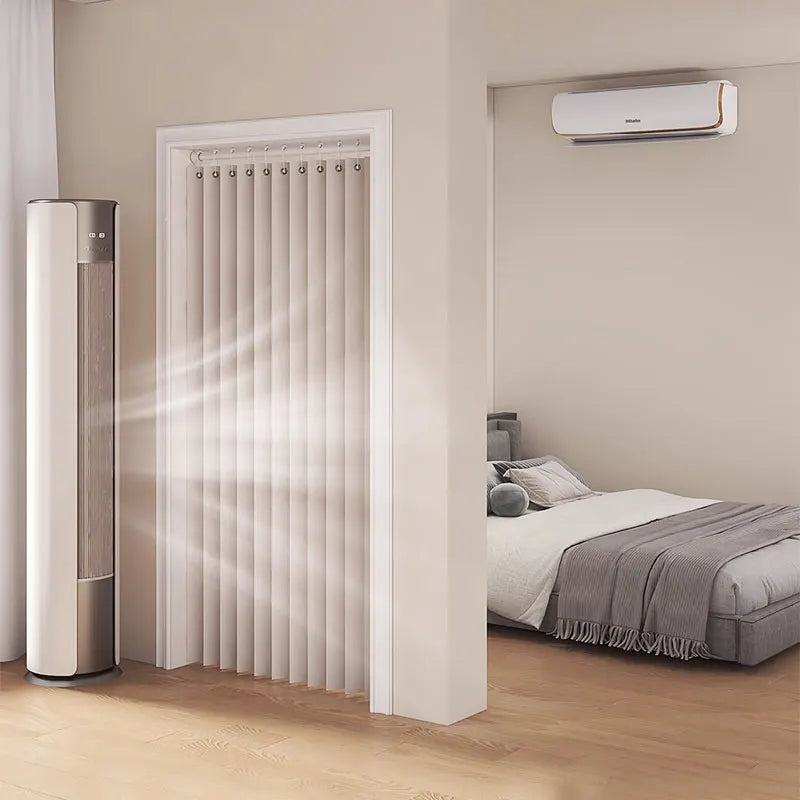 A vertical, light-colored foldable door curtain is shown installed in a white door frame, next to a bedroom with a window-mou