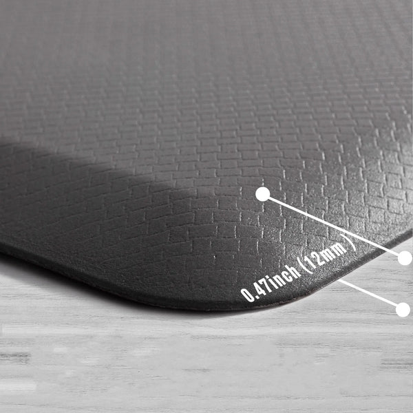 A close-up view of a black anti-fatigue PVC kitchen mat showing its thickness measurement.