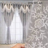 A pair of sheer and embroidered dual-layer window curtains in gray and white lace fabric.
