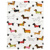 A white flannel blanket featuring a repeating pattern of various dog breeds in brown, black, and multicolored designs.
