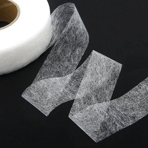 Roll of clear double-sided iron-on adhesive tape for garment repair