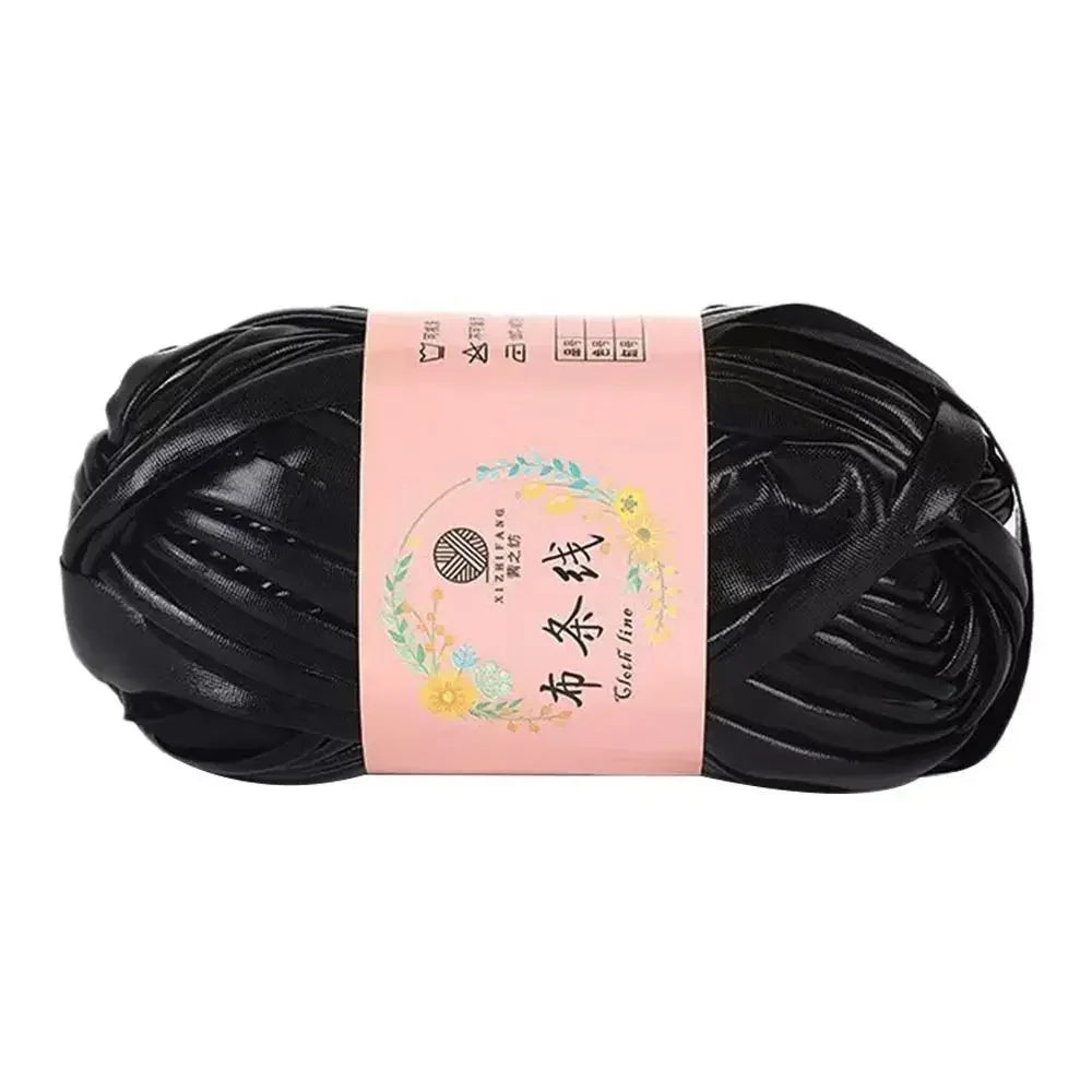 Black ice rope crochet yarn for crafting displayed on a light pink label.