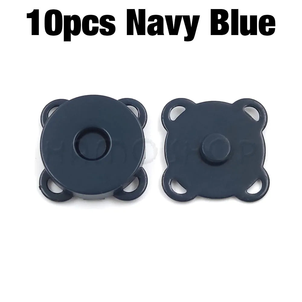 A pair of dark navy blue metal magnetic snap buttons for sewing.