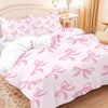 Pink butterfly pattern bedding set featuring a duvet cover and pillows on a bed.