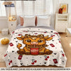 A beige flannel blanket featuring a cartoon Highland cow print with a red pepper can design.