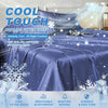 A blue cooling fitted sheet with snowflake patterns is displayed on a bed, emphasizing cool touch and comfort.