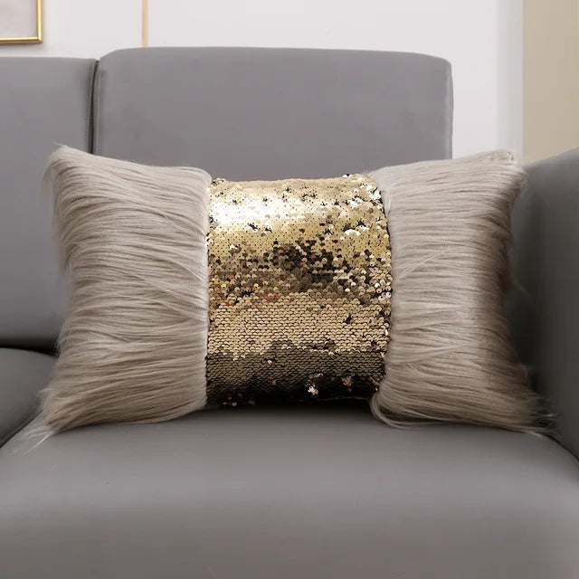 A decorative cushion cover featuring a gold sequin fabric surrounded by long, light gray faux fur.