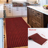 A black-red striped runner rug placed on a wooden floor in a modern kitchen setting.