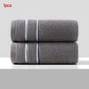 Two gray ultra-absorbent pure cotton face towels are displayed side by side.