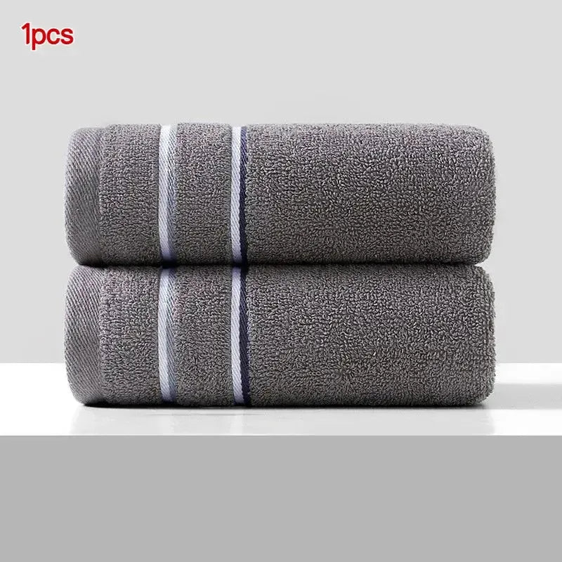 Two gray ultra-absorbent pure cotton face towels are displayed side by side.
