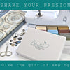A white sewing machine and a box of 42-color polyester thread spools are displayed with scissors.