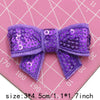 Purple sequin bow patches for DIY decoration shown on a pink grid background