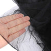 Close-up of a hand holding black mosquito netting fabric over a dark background.