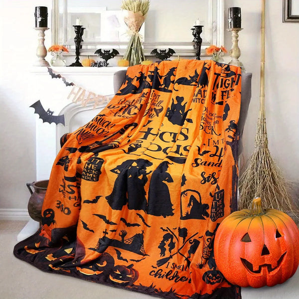 Orange and black flannel blanket featuring spooky witch silhouette designs and Halloween themes.