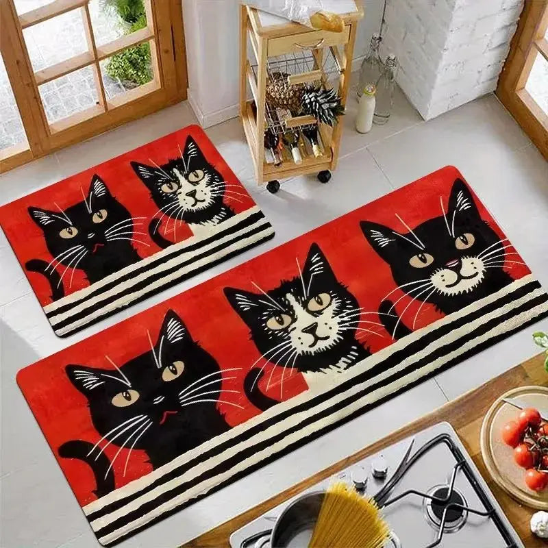 A rectangular red kitchen mat featuring a black cat print with white accents and black stripes.