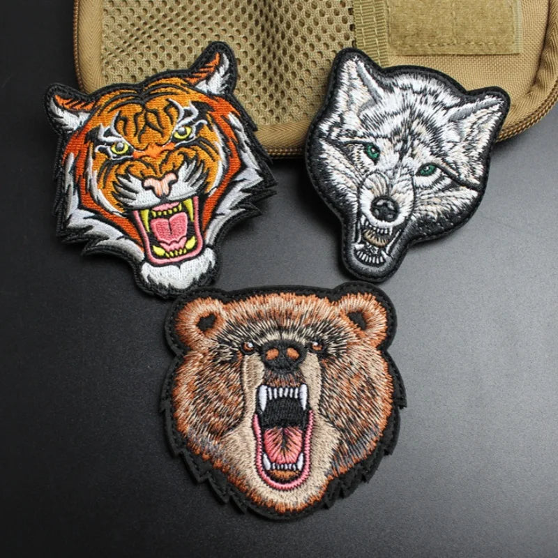Three embroidered animal morale patches featuring a tiger, wolf, and bear head.