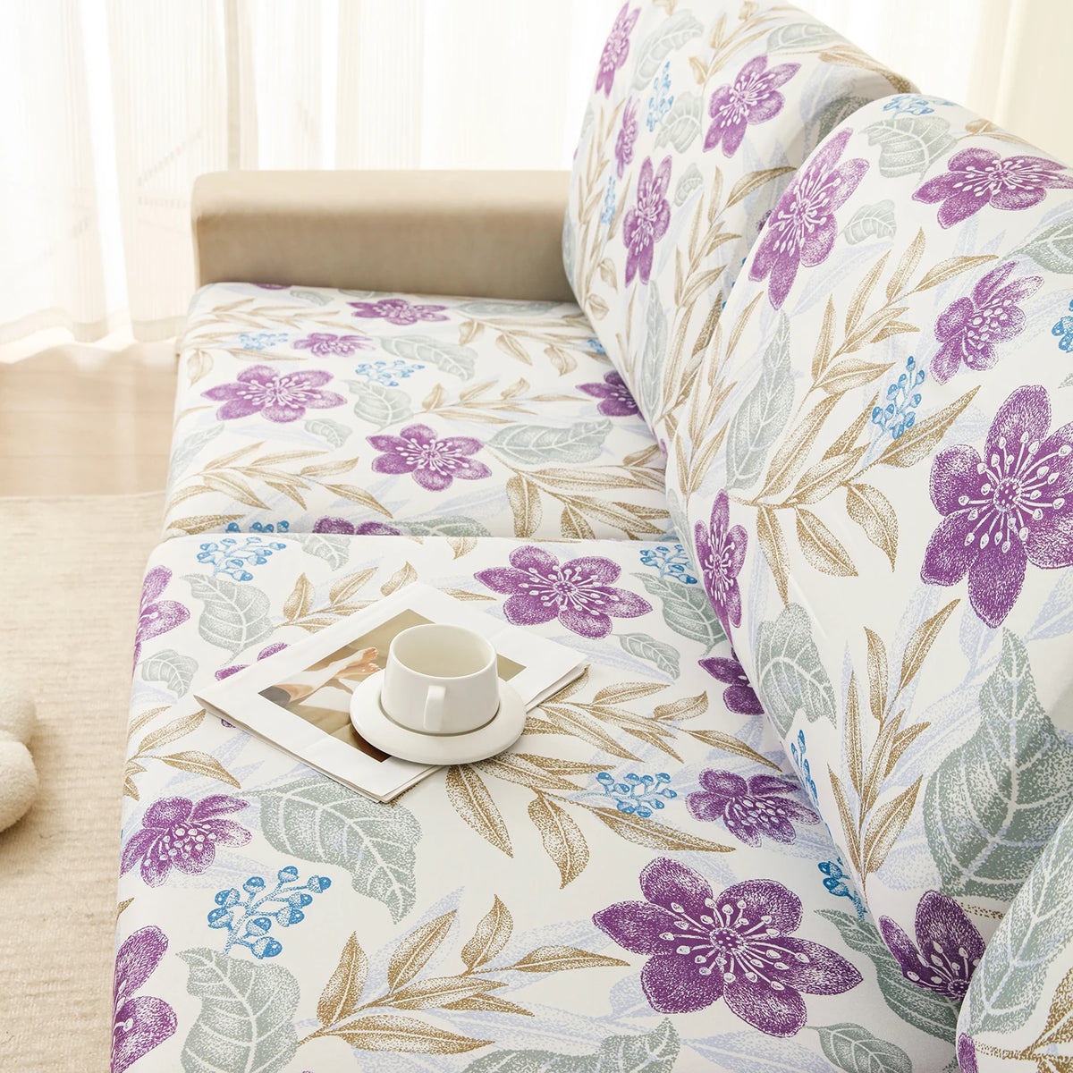 A floral print elastic sofa protective cover featuring purple and green leaves on a light background.