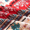 Close-up of red and white bohemian printed linen fabric showing intricate floral patterns and textures.
