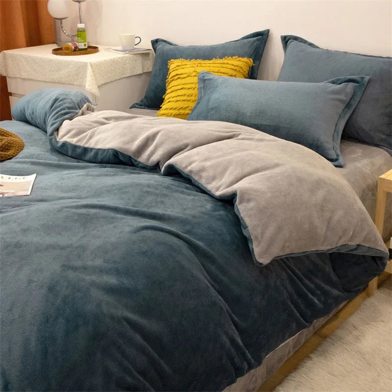A dark blue luxurious flannel duvet cover set with gray and yellow accent pillows on a bed.
