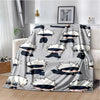 A gray throw blanket featuring a repeating pattern of Jujutsu Kaisen anime characters with white and dark blue hair.