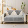 A beige plush sofa cover with gray accents and tiger embroidery displayed in a bright, modern living room.