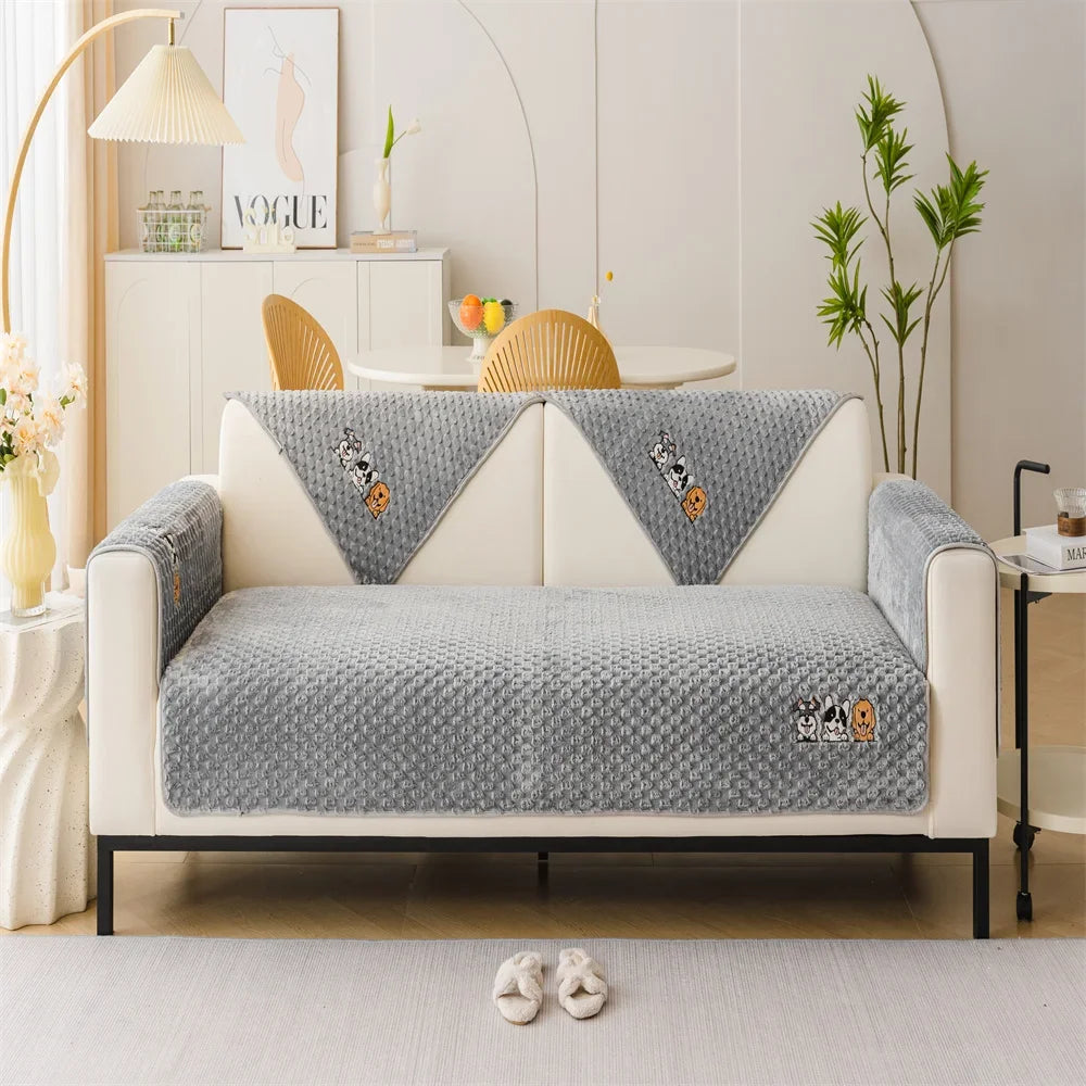 A beige plush sofa cover with gray accents and tiger embroidery displayed in a bright, modern living room.
