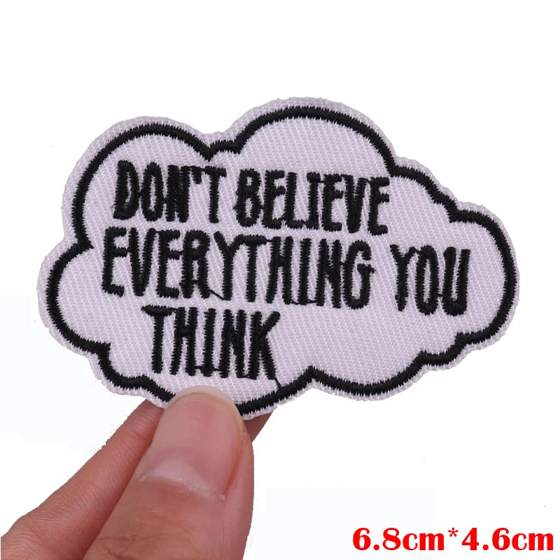 White embroidered patch shaped like a cloud with black text that reads Don't believe everything you think