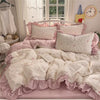 Pink and white princess style ruffle bedding set with pillows and a duvet on a bed.