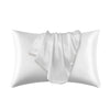 A white satin silk pillow cover is shown folded and lying on a white background.