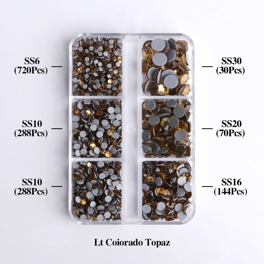 A clear plastic tray containing various sizes of gold and dark brown glass rhinestones categorized by SS6, SS10, SS10, SS20, 