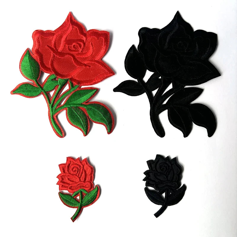 Two embroidered rose flower patches, one red and one black, featuring green leaves.