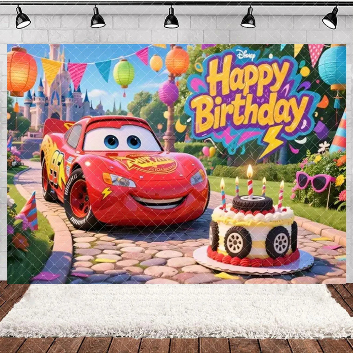 A Disney-style cartoon race car is featured in a birthday party backdrop with colorful balloons and festive decorations.